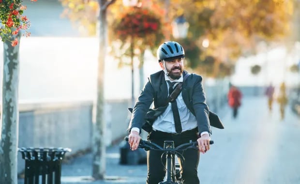 person_riding_bicycle_through_city_hero.jpg